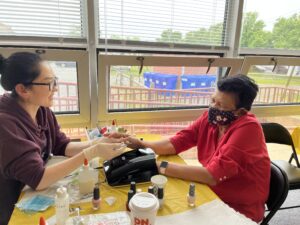 Teachers and a parents get manicure done