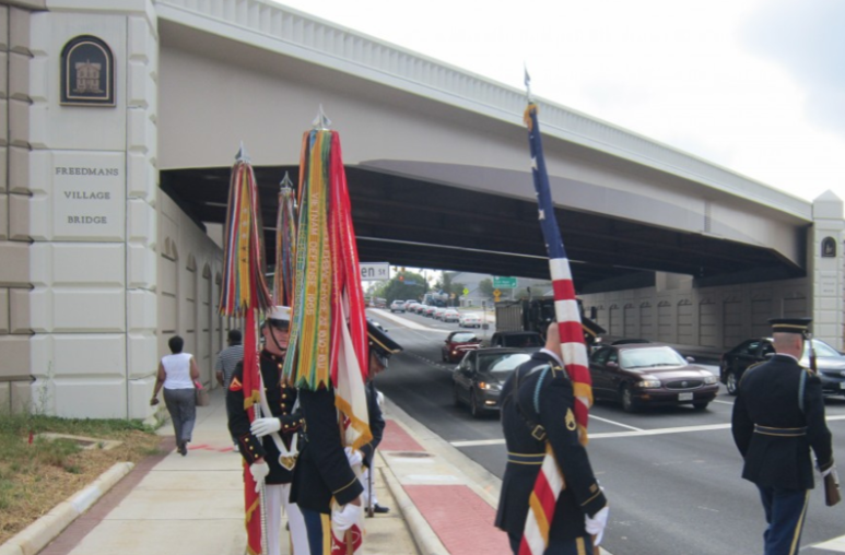 At Freeman Bridge in Arlington, VA; Marine Corp carrying American flag and Marine flag.