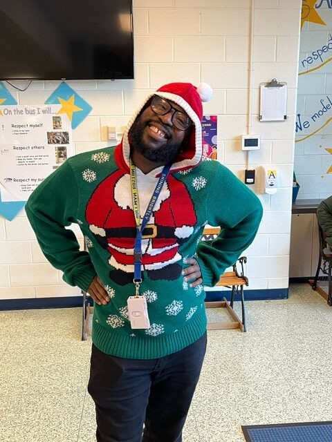 A teacher wearing Santa sweater.