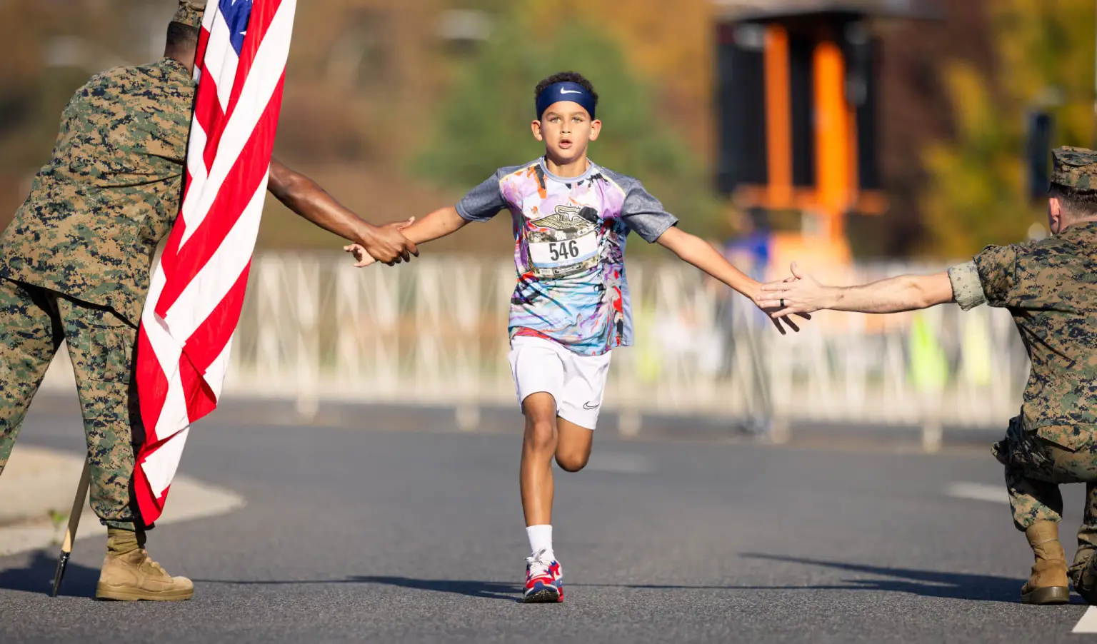 kid running while giving marines hand shake.