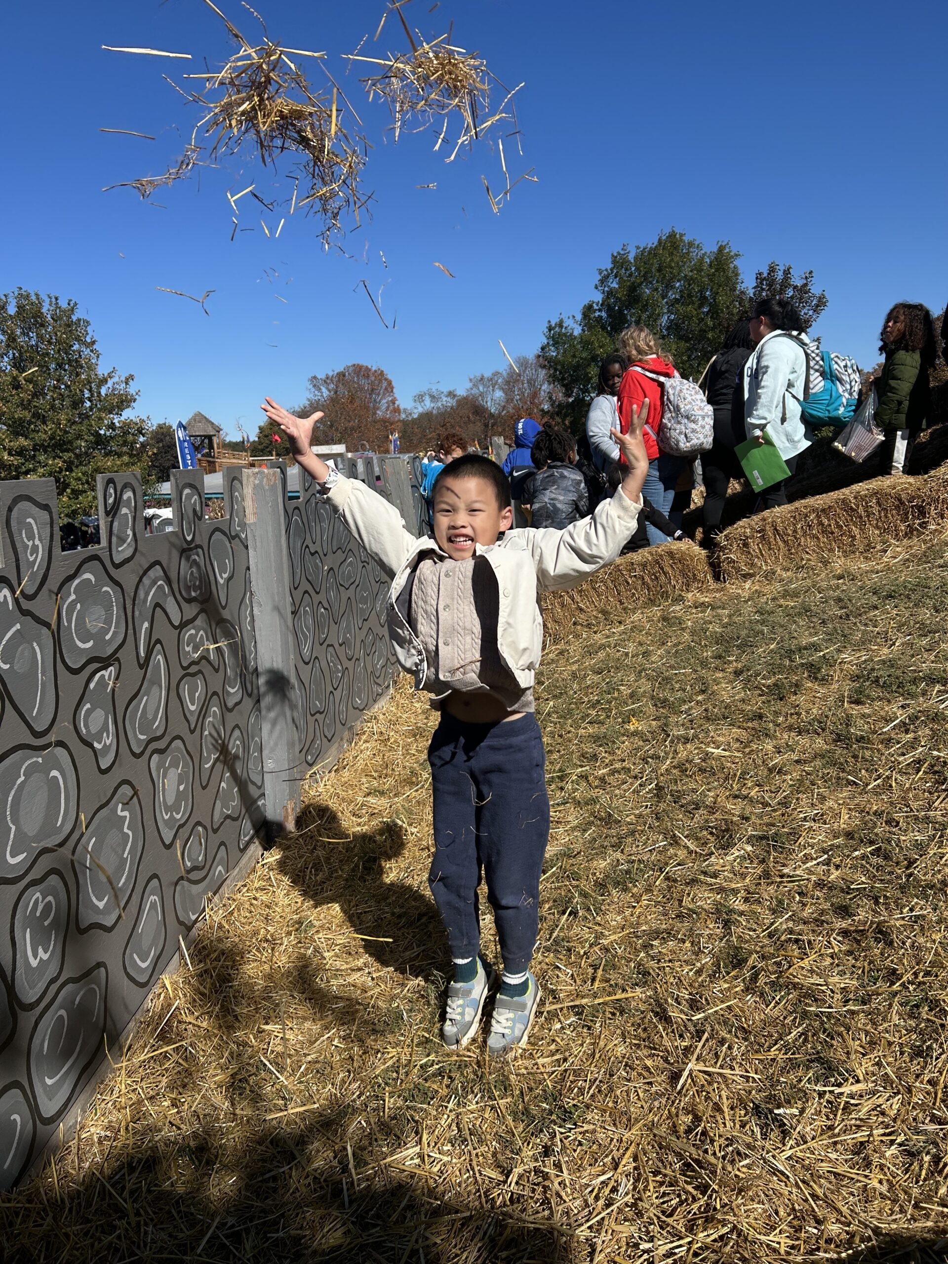 A students throwing hay in the air