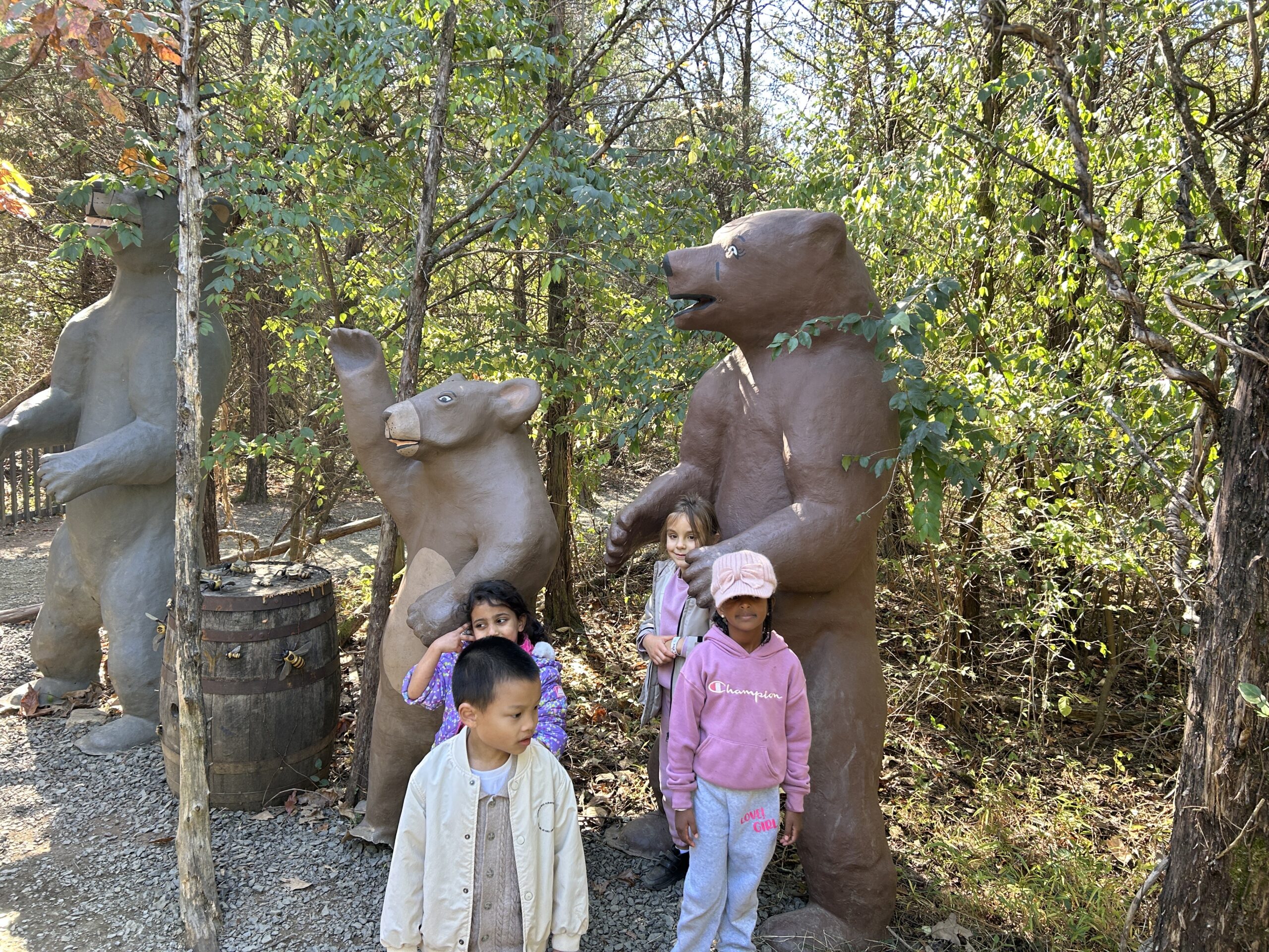 Students post in front of bears stature