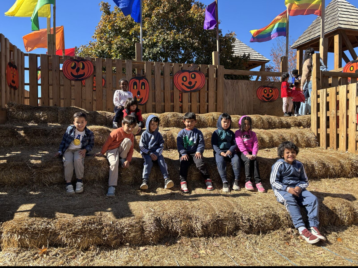 Students post in front of hay stack
