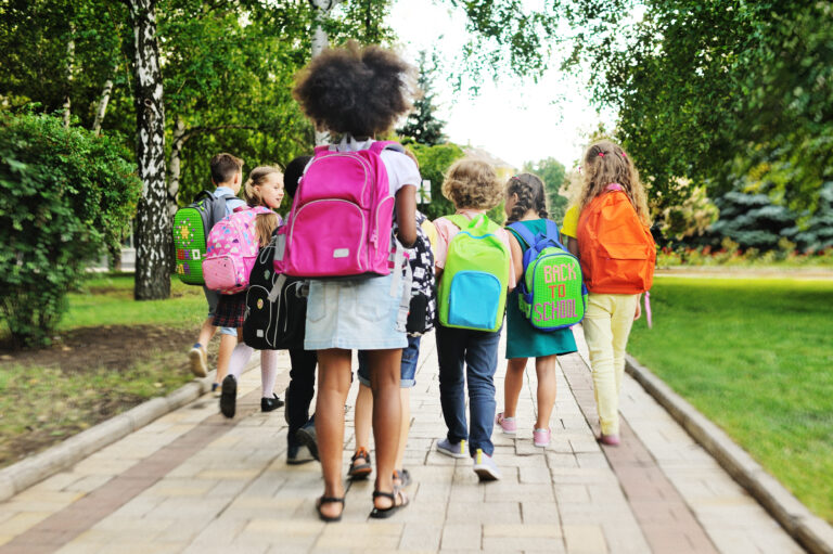 children walking with colorful backpacks